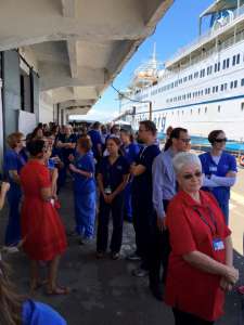 Mercy Ships healthcare staff gathered outside the ship