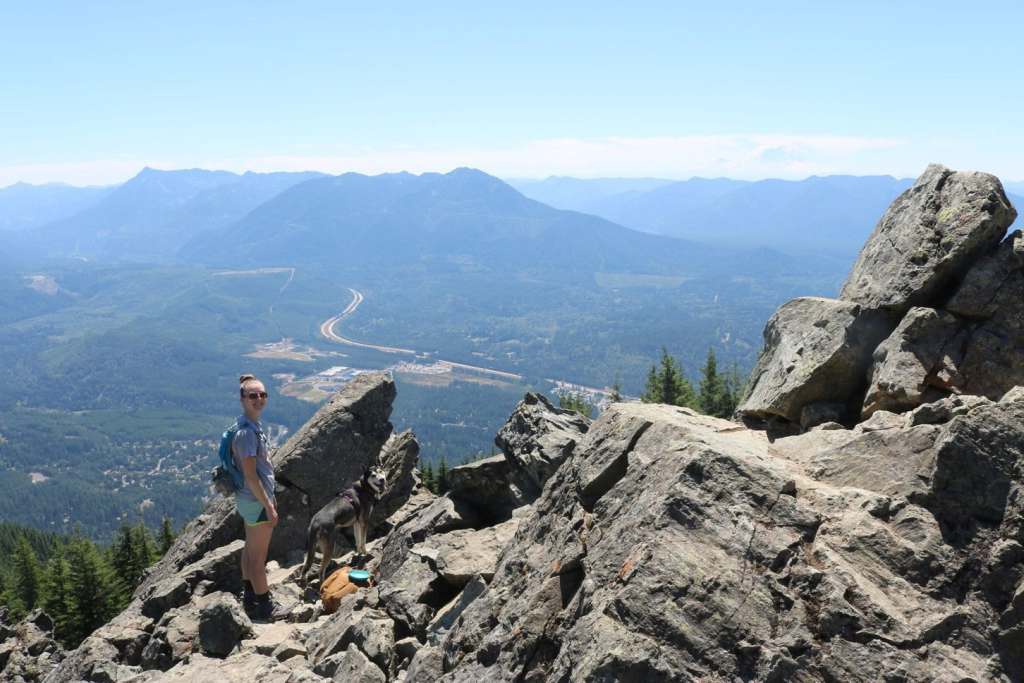 Industry-Leading Benefits: Accident Insurance travel nurse with her dog on a trail in the pacific northwest