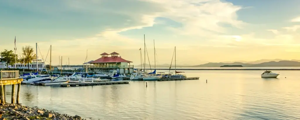 The harbor at sunset in Burlington, Vermont. Burlington is known for its local charm, bustling arts scene, live music, and cozy cafes.