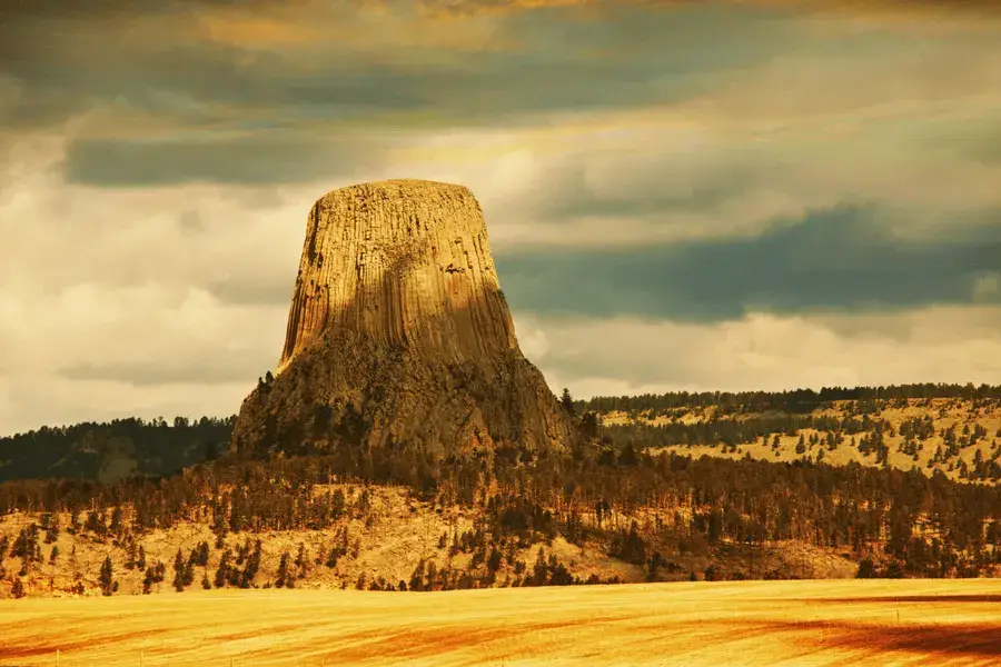 Top Bucket List Things To Do During Your South Dakota Assignment image of tall rock tower surrounded by fields