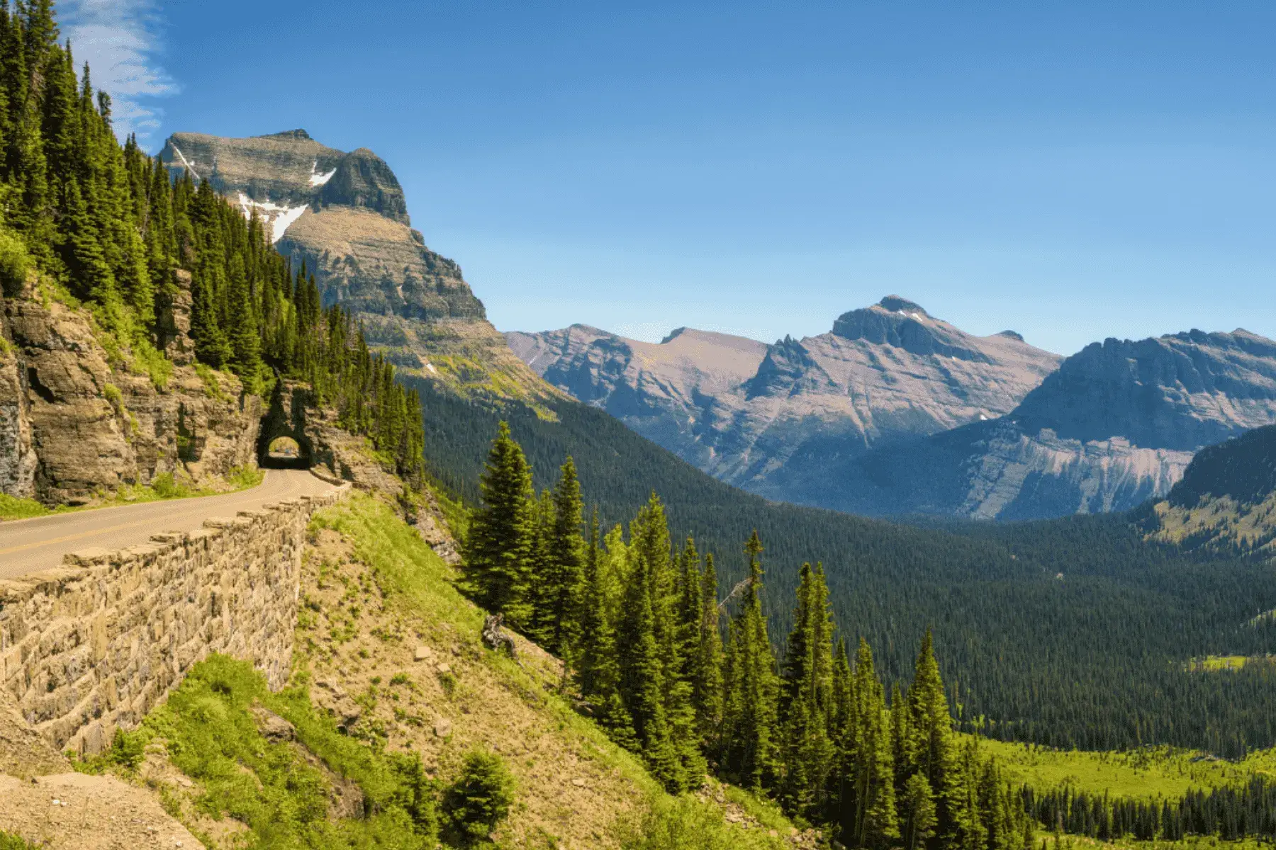 view of a road overlooking mountains and trees