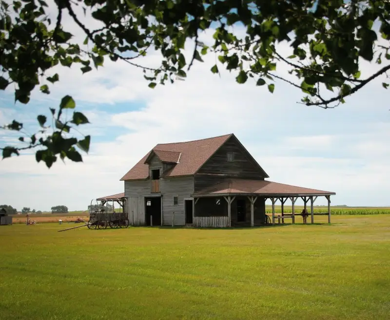 Top Bucket List Things To Do During Your South Dakota Assignment image of a pioneer home on field in South Dakota